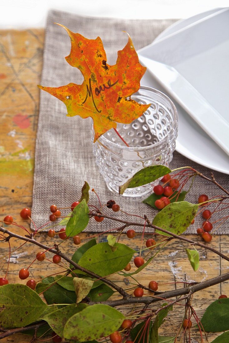 Herbstlich dekoriertes Tischgedeck mit Laubblatt als Namensschild