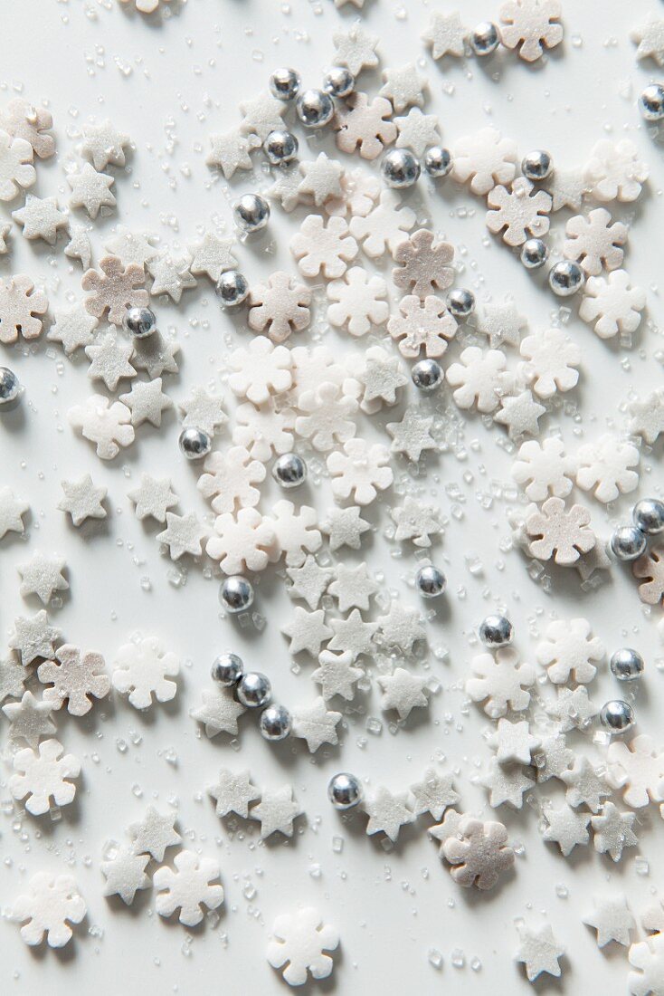 Christmas cake decorations sprinkled on a marble surface