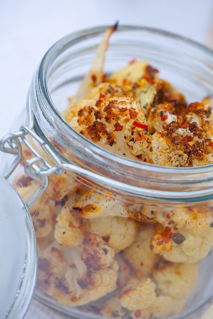 Oven-roasted cauliflower in a flip-top glass jar for a picnic
