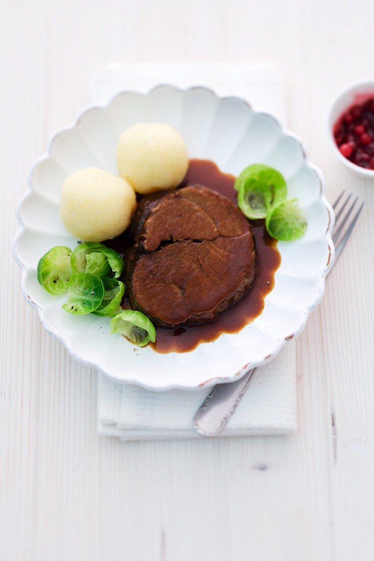 Venison pot roast with potato dumplings and brussels sprouts