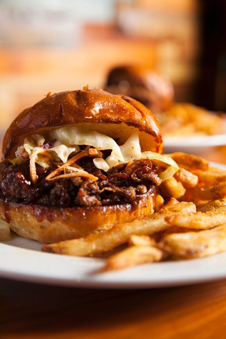 Barbecue sandwich witch coleslaw and french fries
