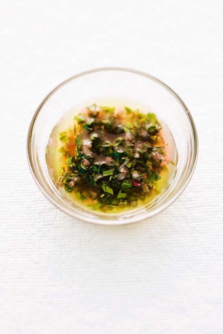 Herb vinaigrette in a glass bowl