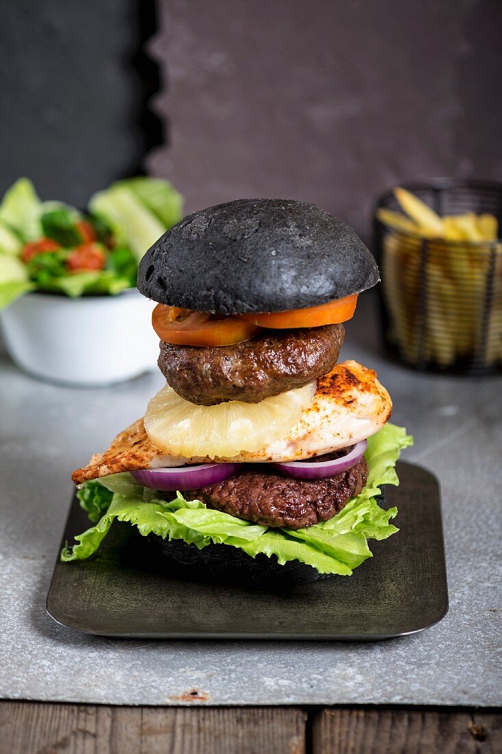 Beef, Chicken and Pork burgers in a black bun