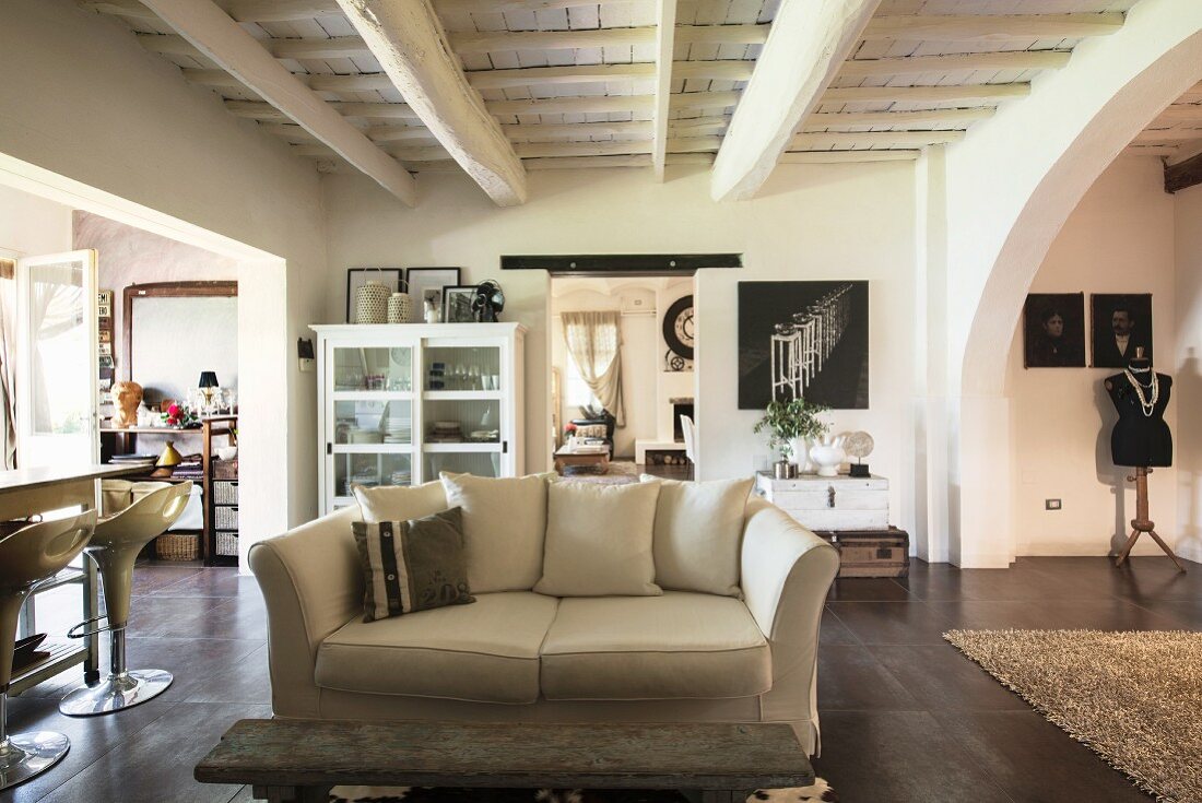 Open-plan interior in converted wine cellar with wood-beamed ceiling