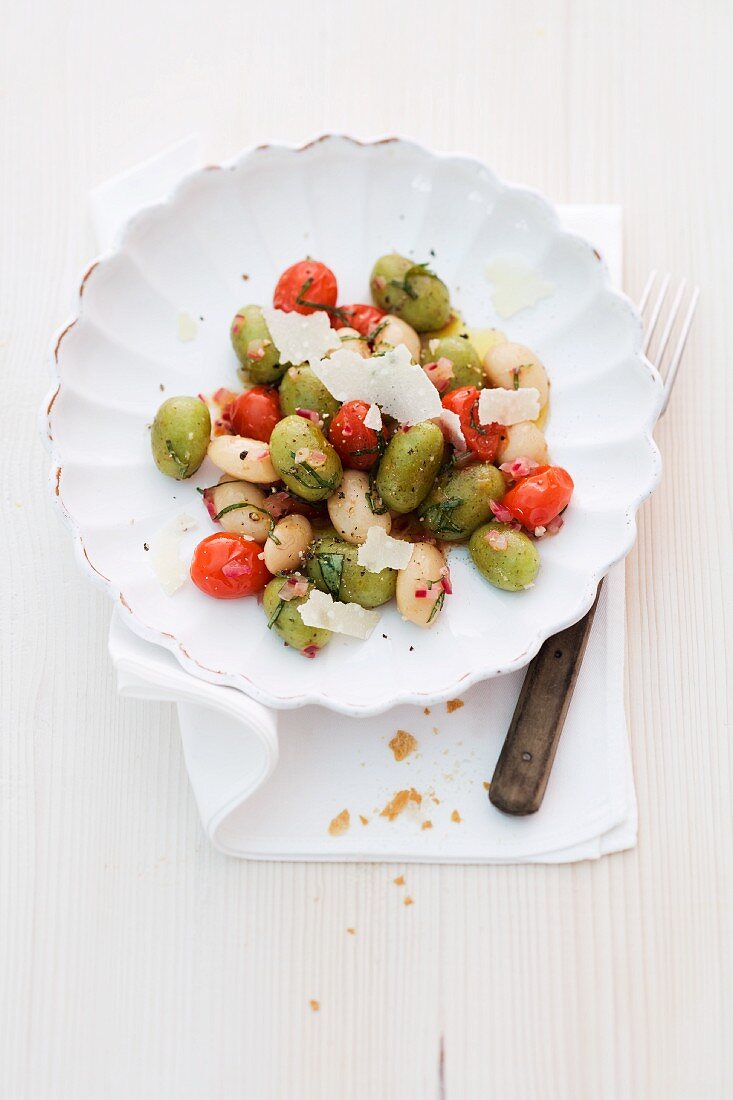 Basil gnocchi with cherry tomatoes and white beans