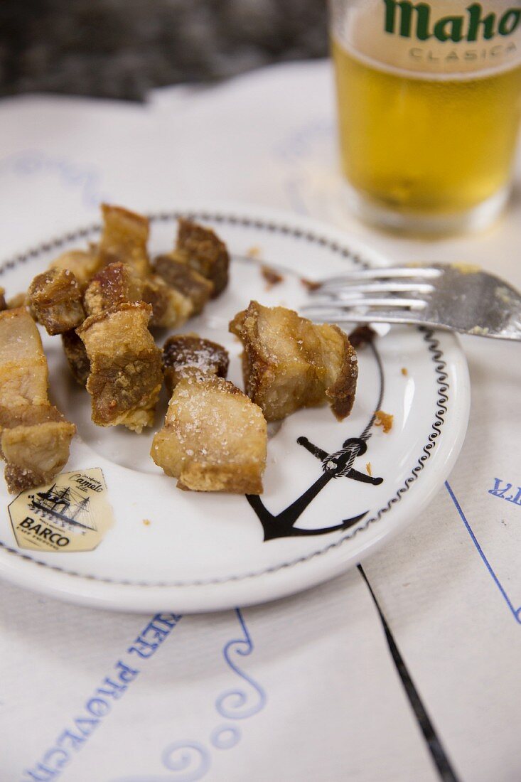 Crispy deep-fried bacon at the Mercado de la Paz in the Salamanca district of Madrid, Spain