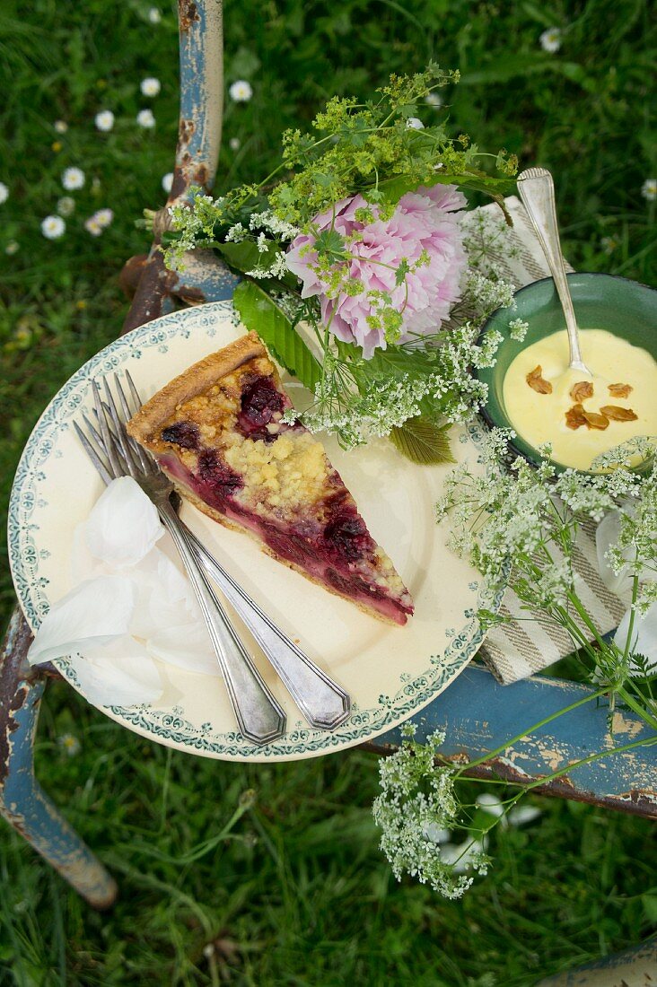 Cake, pudding and flowers on chair for garden picnic