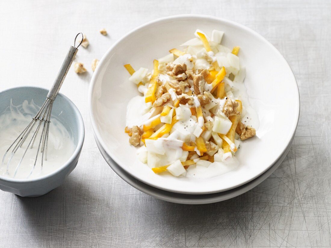 Fennel salad with walnuts, persimmon and a honey and yoghurt dressing (low lactose)