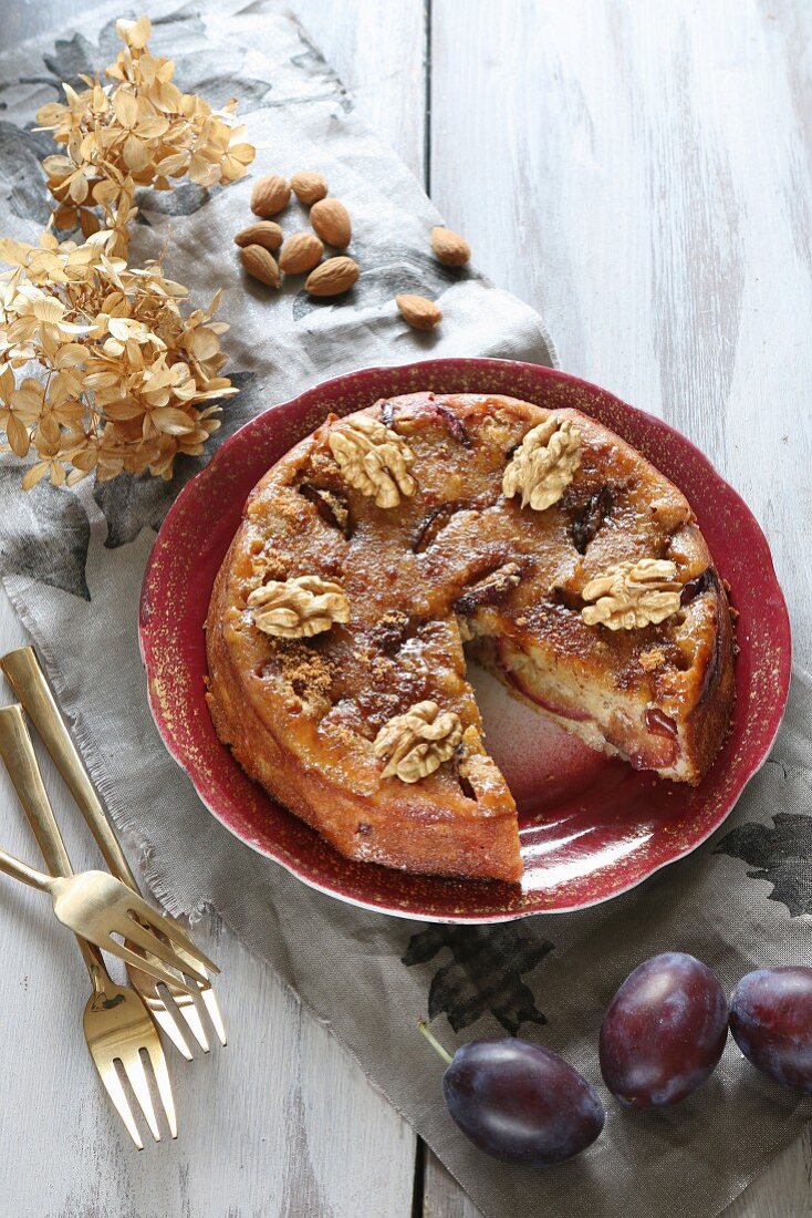 Gluten-free plum cake with walnuts, almonds and coconut blossom sugar (top view)