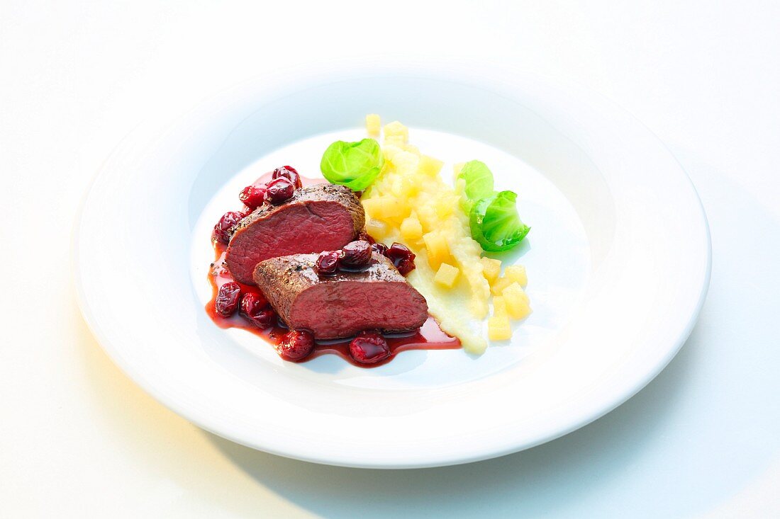 Venison with cranberry sauce and quince and potato mash