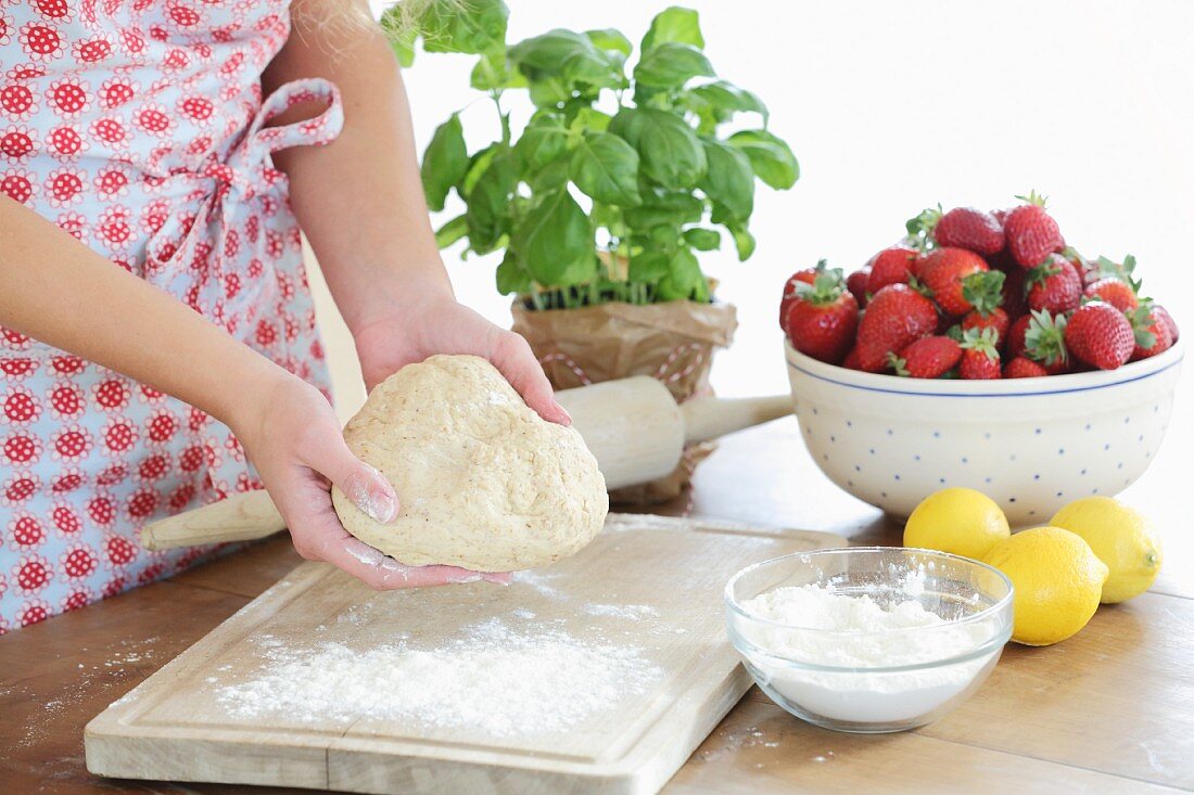 Yeast dough, strawberries, flour, lemons and basil