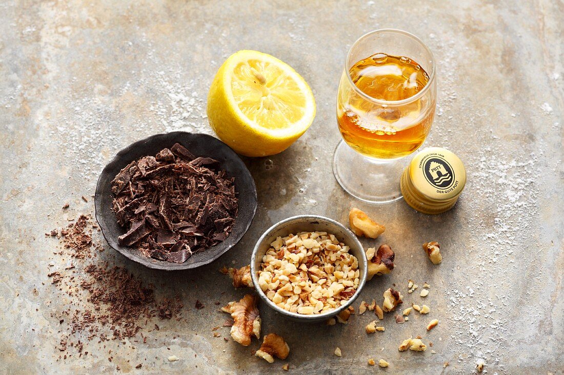 Baking ingredients: chocolate flakes, chopped walnuts, rum and lemon