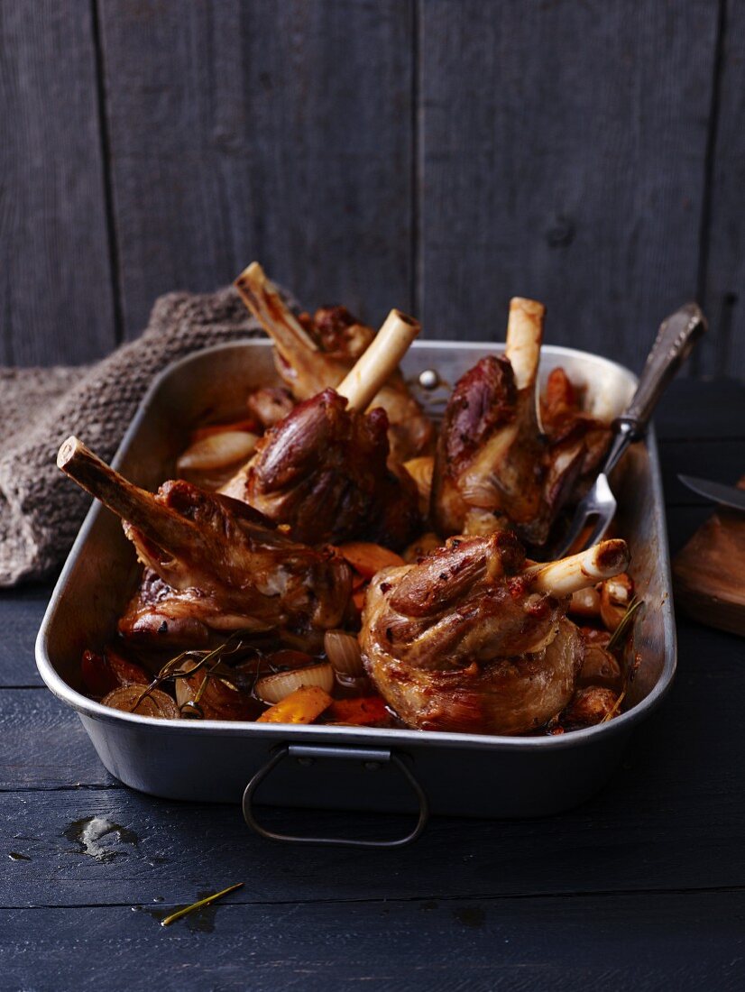 Braised lamb shanks in a roasting tray