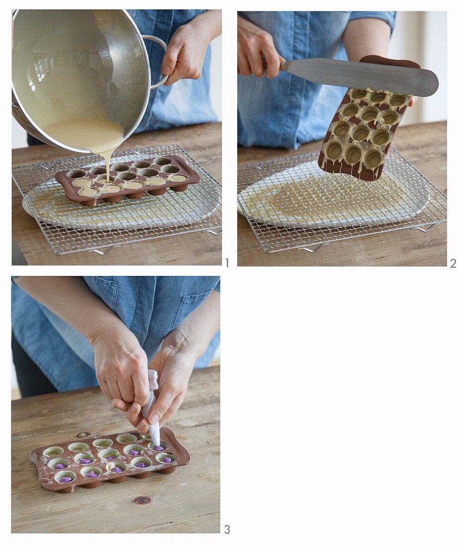 White pralines with raspberry filling being made