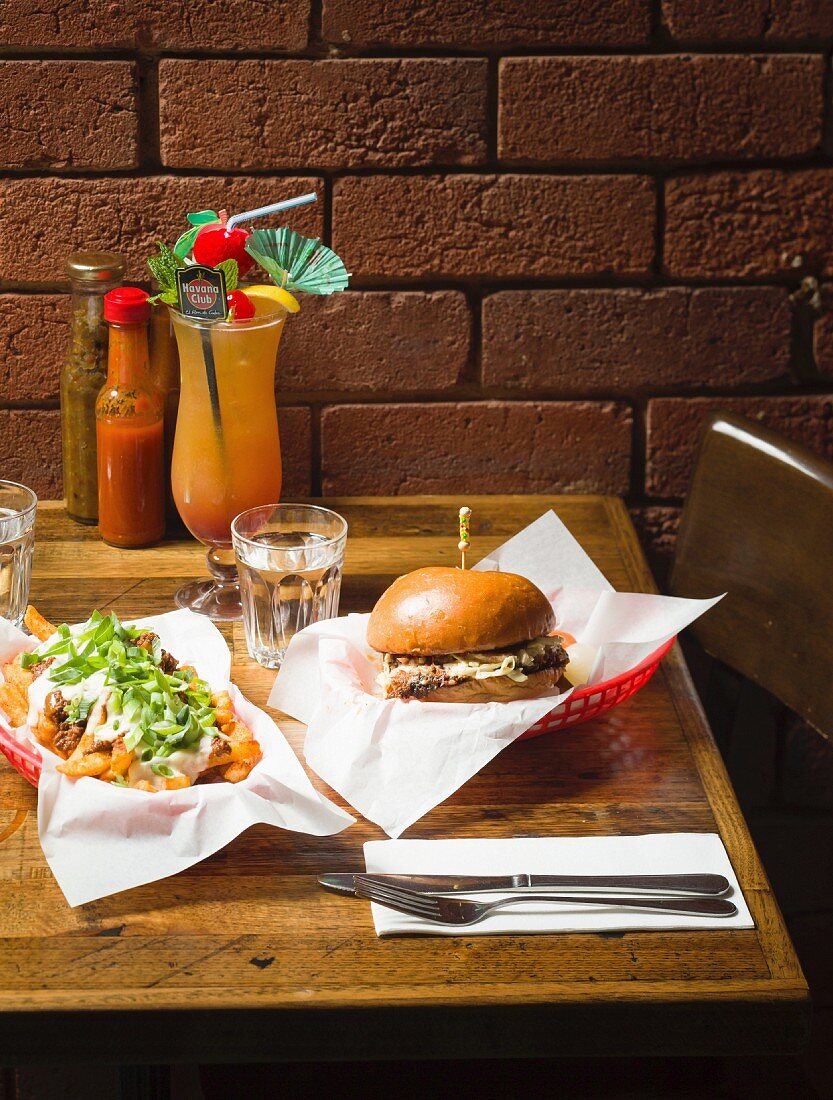 A beef brisket sandwich with chili cheese fries and a cocktail in a restaurant (Melbourne, Australia)