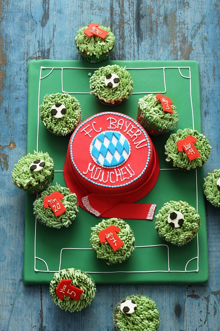 A fondant icing cake and cupcakes for football fans