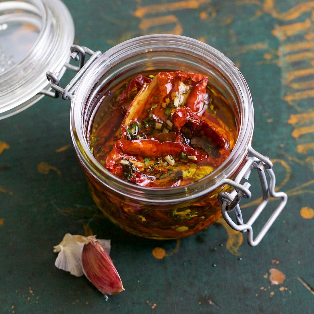 Home-dried tomatoes preserved with herbs in olive oil