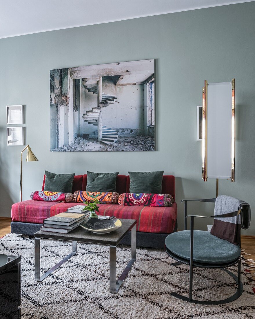 Stylish mixture of furniture in living room with dove-grey walls