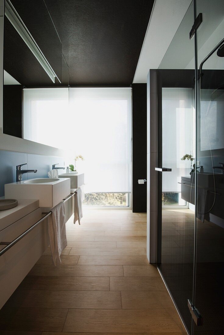 Rectangular sinks and wood-effect tiles in modern bathroom