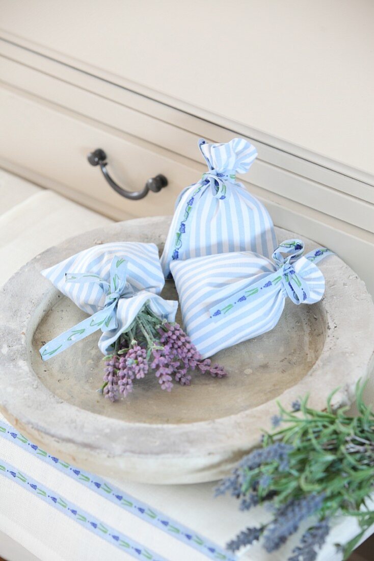 Pale blue lavender sachets in stone dish