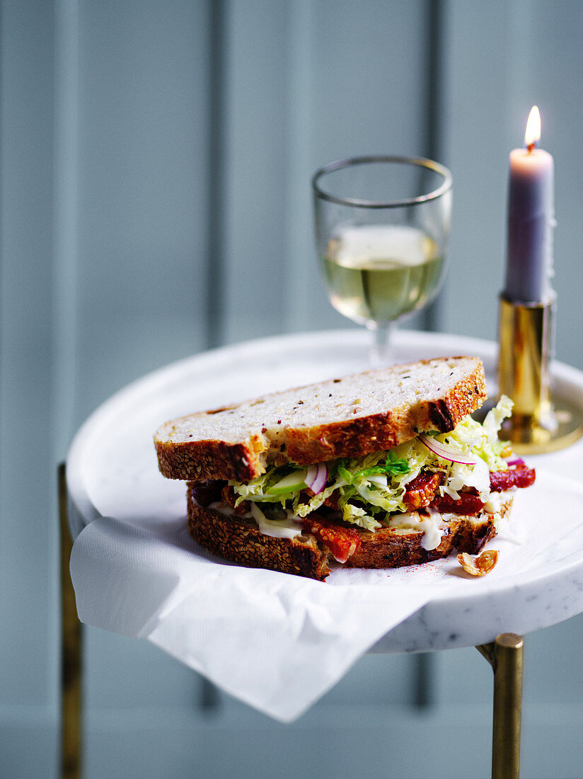 Sandwich with crispy bacon and apple and cabbage salad