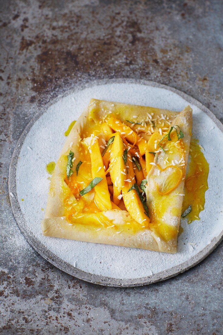 Sugar-free coconut crepes with mango and fresh Thai basil