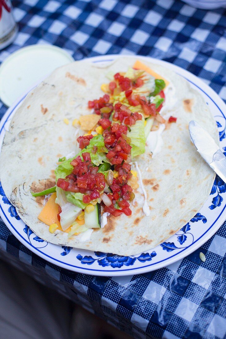 A burrito on a camping table