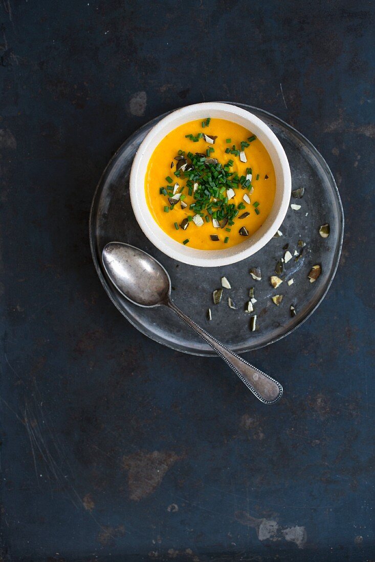 Pumpkin soup with chives and chopped pumpkins