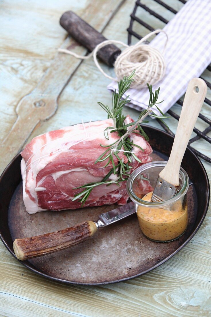 Raw cutlet of herb infused pork with a mustard and honey marinade