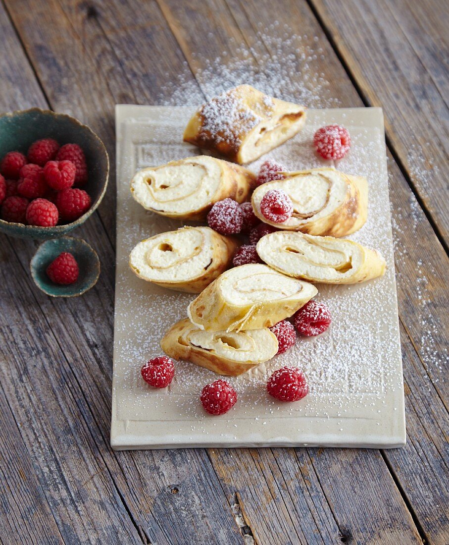 Pancake rolls filled with lemon cream and raspberries