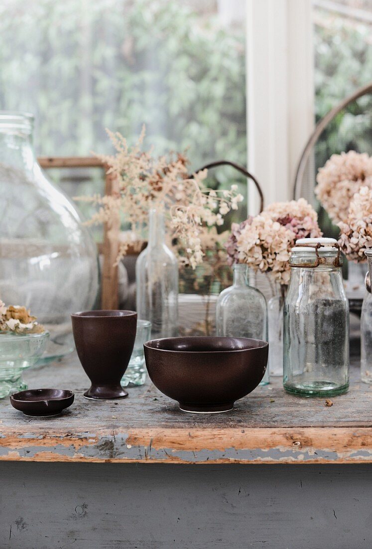 Dried hydrangeas in old glass bottles