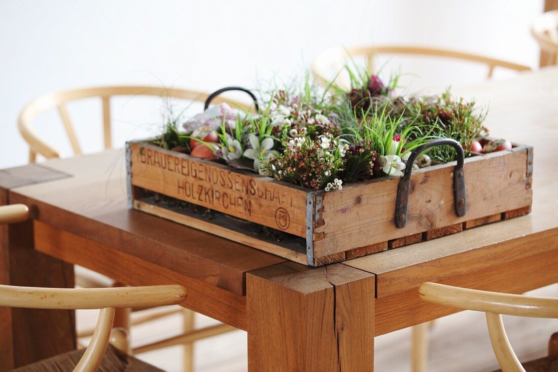 Easter flower arrangement in vintage bottle crate