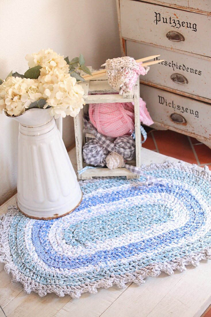 Crocheted, oval, rag-yarn rug in shades of blue