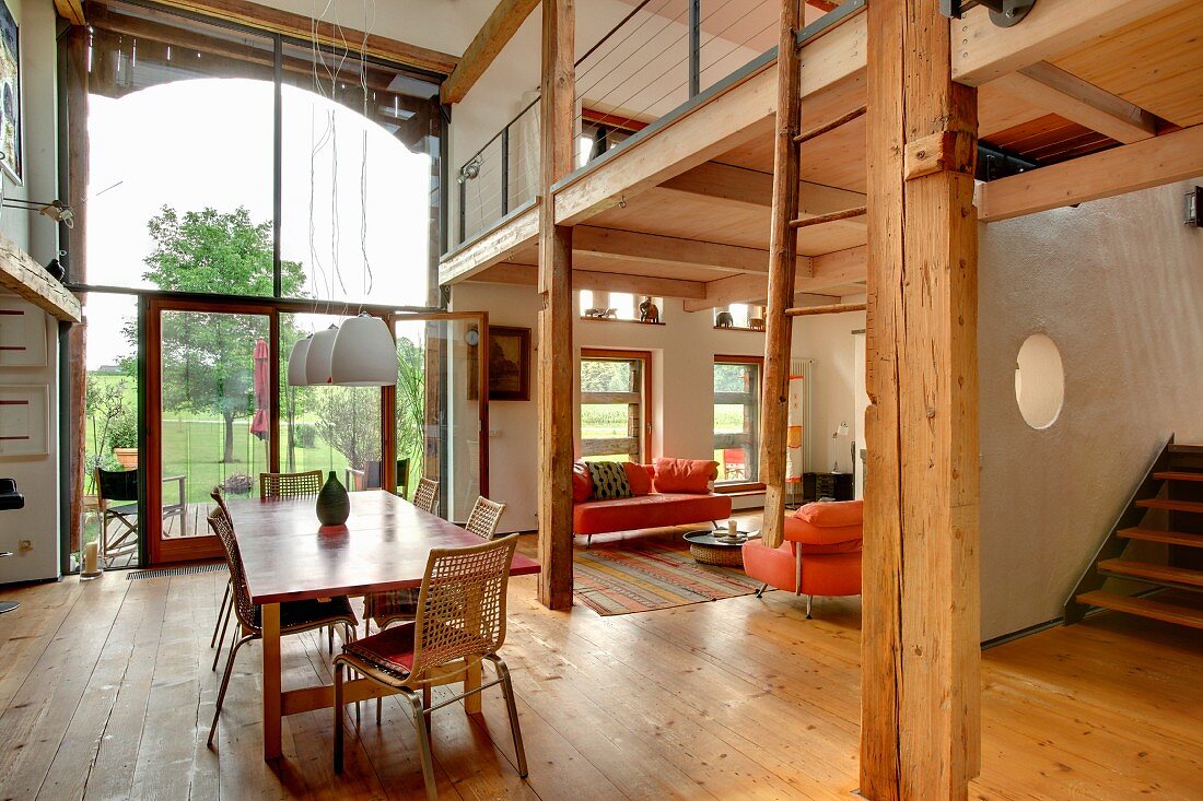 Open-plan interior with rustic, modern atmosphere, gallery and glazed barn door