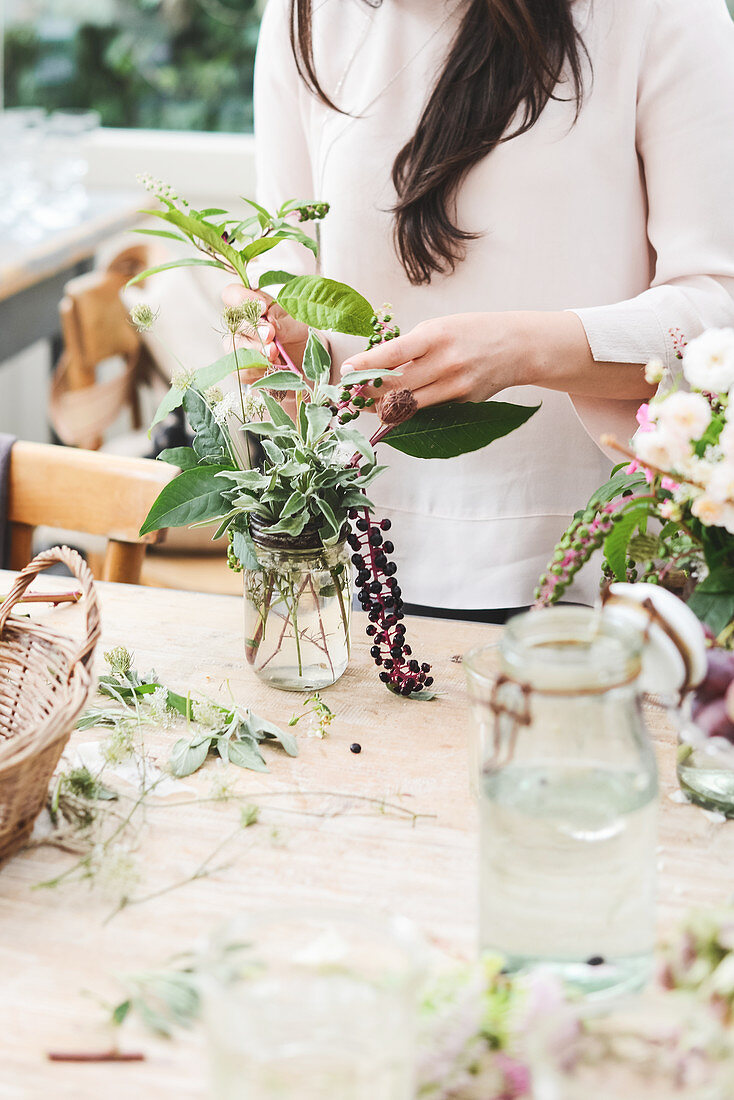 Woman arranging autumnal bouquet