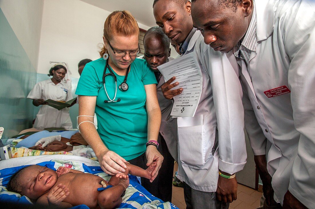 Hospital doctors examining babies