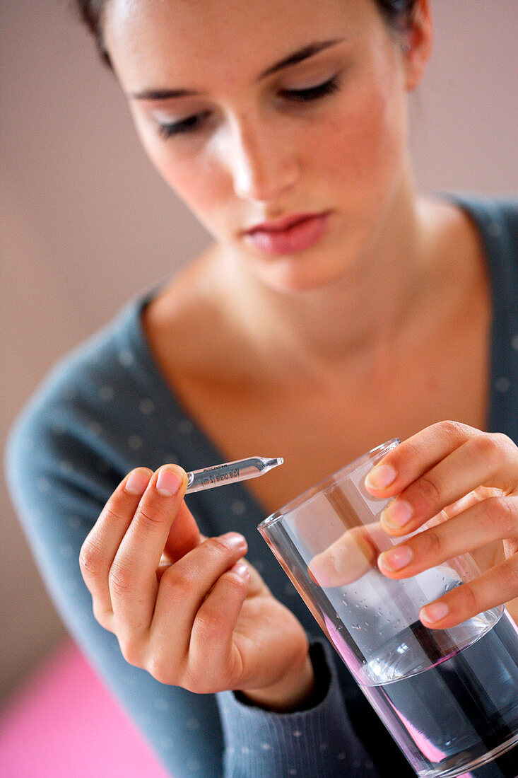 Woman with glass ampoule