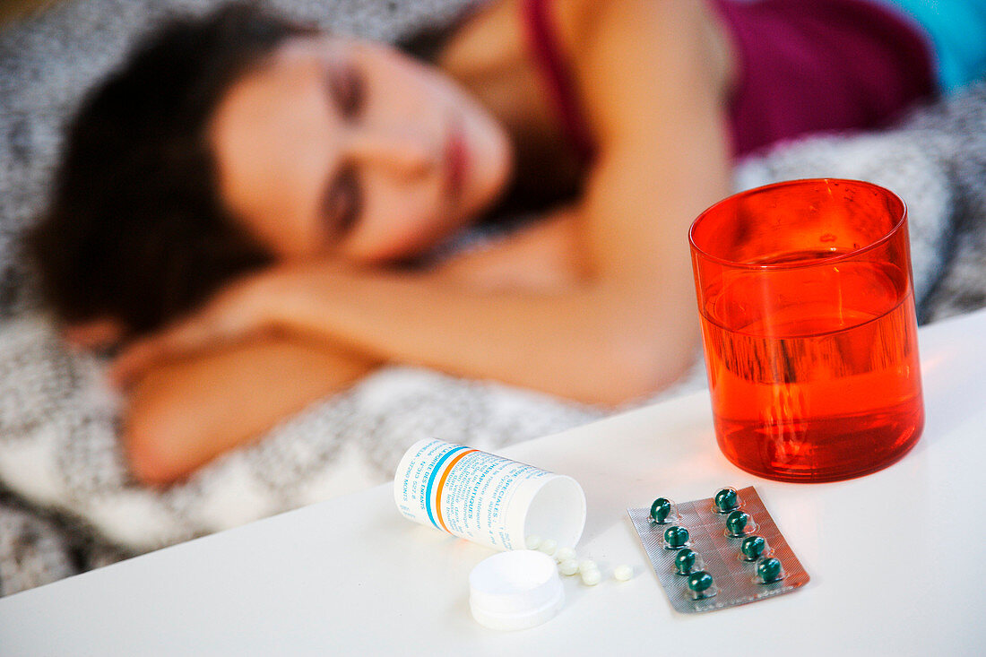 Sleeping woman with pills