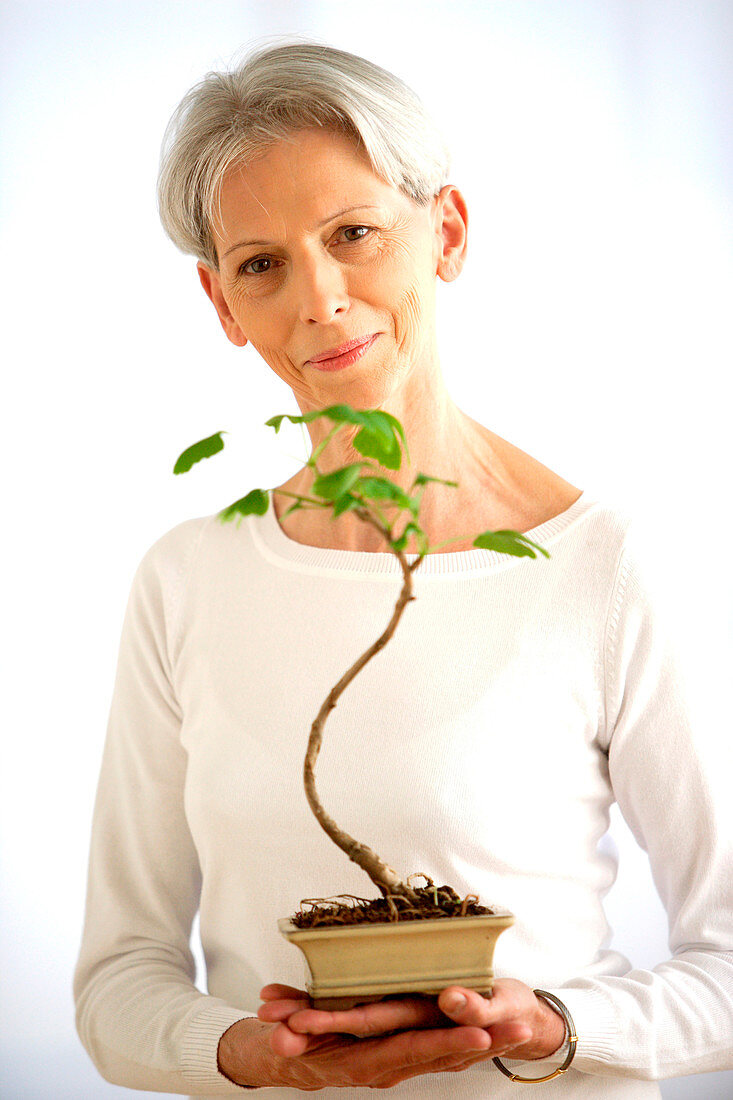 Woman with bonsai