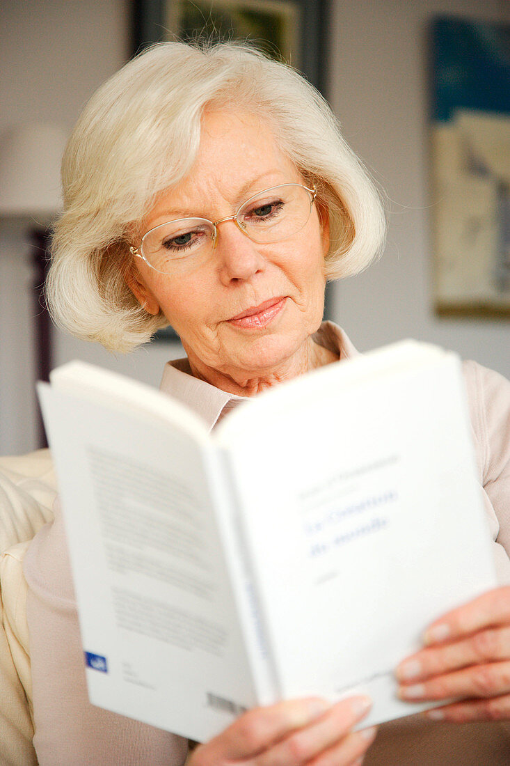 Elderly person reading book
