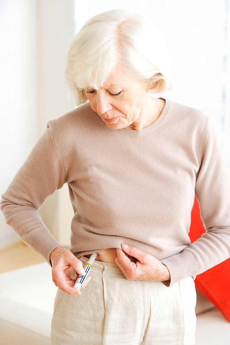 Elderly woman injecting insulin