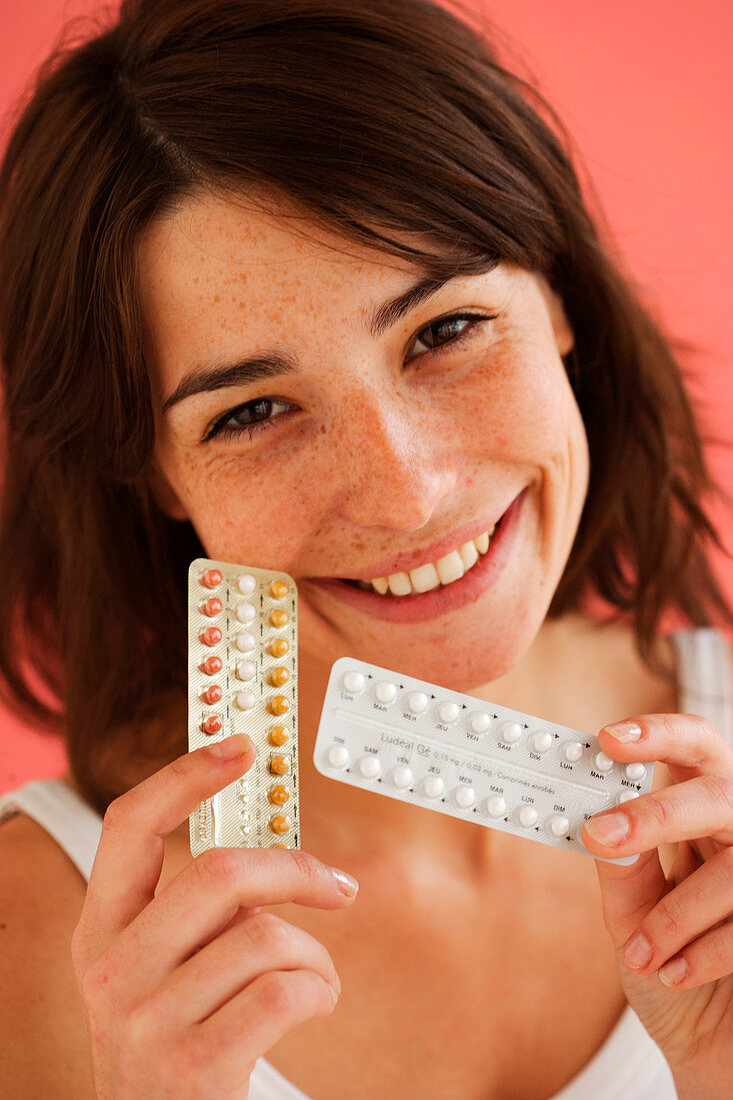 Woman holding contraceptive pills