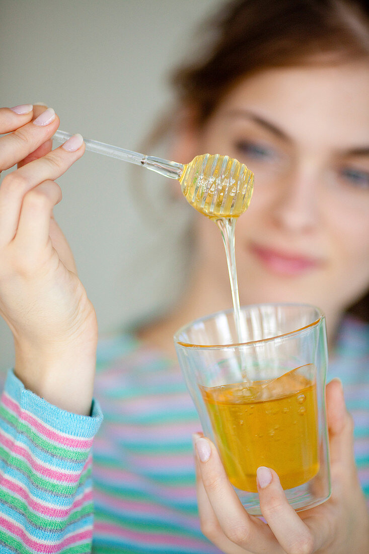 Woman eating honey