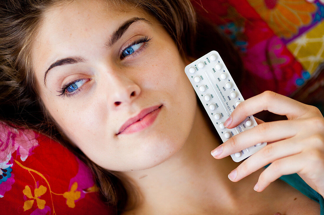 Woman with contraceptive pills