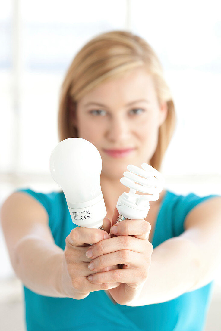 Woman holding energy saving bulbs
