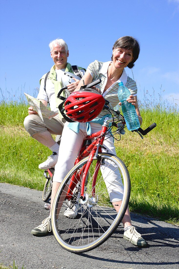 Senior couple riding tandem bicycle