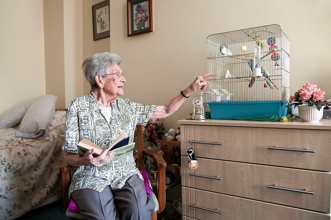 Care home resident and pet bird
