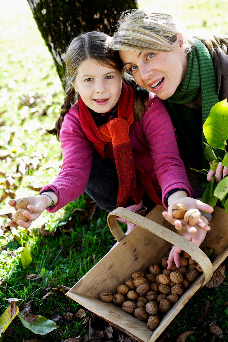 Mother and child picking mushrooms