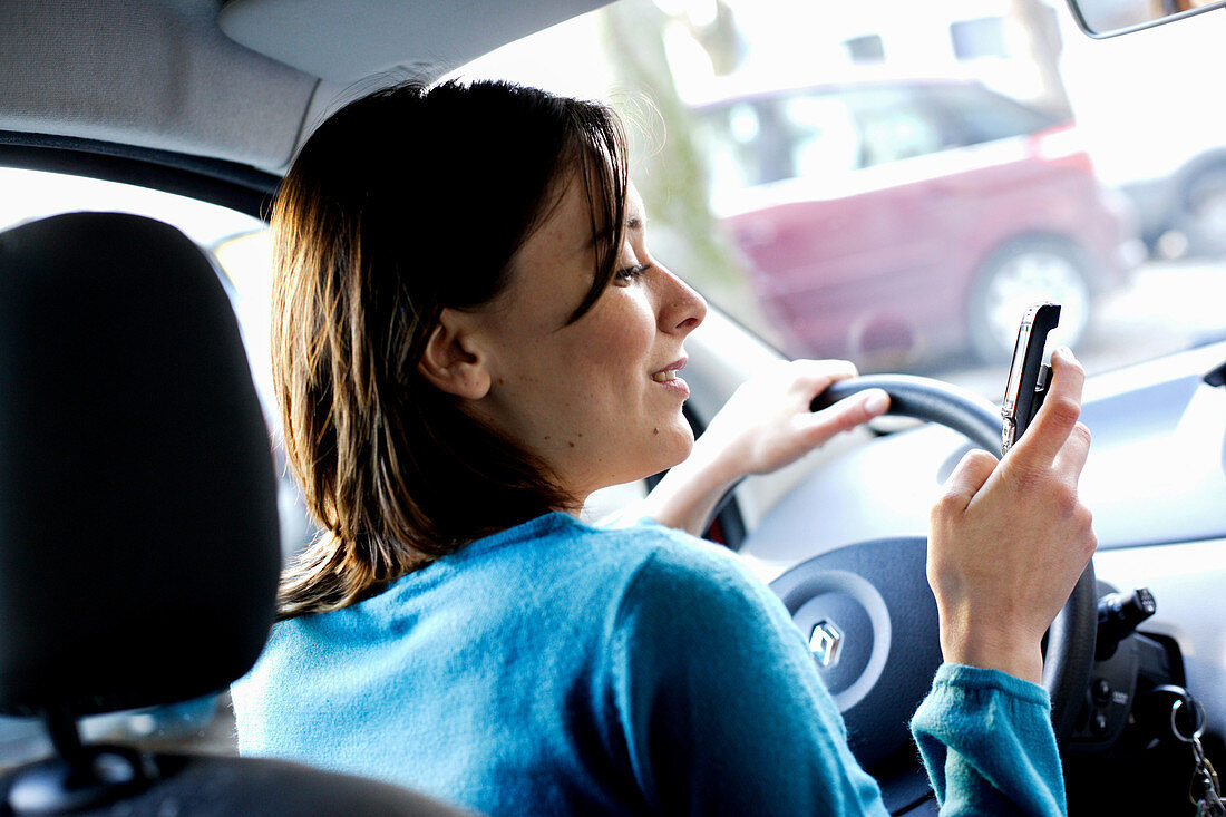 Woman using cell phone when driving