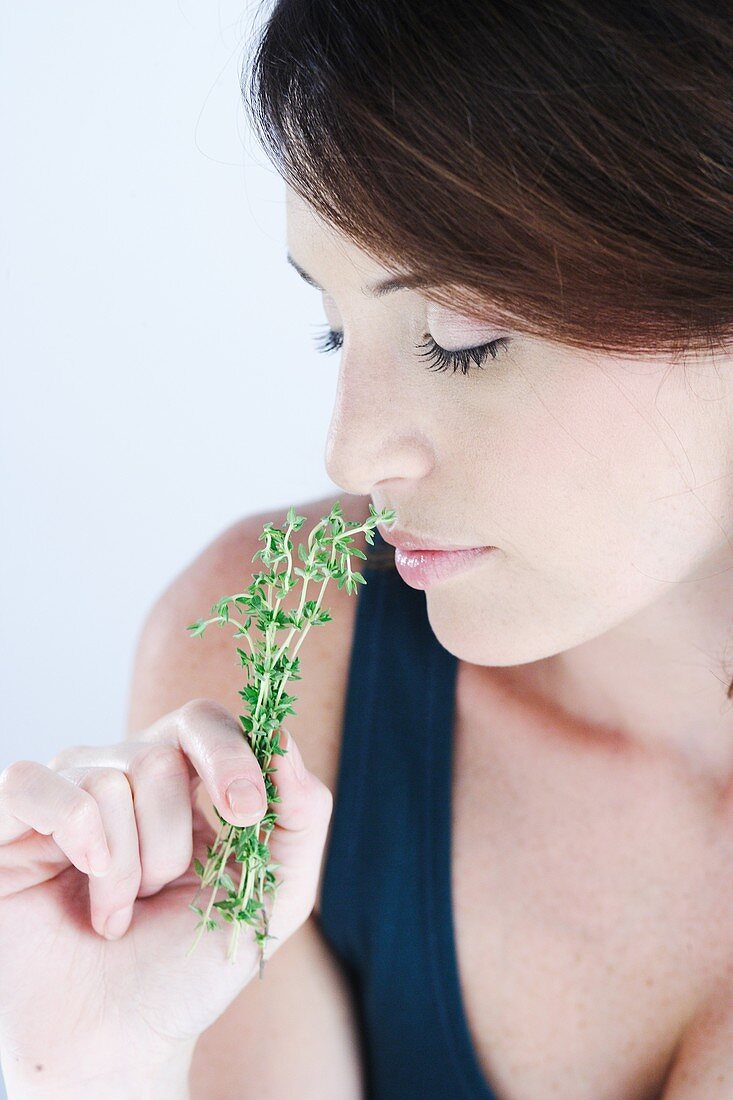 Woman inhaling thyme fragrance